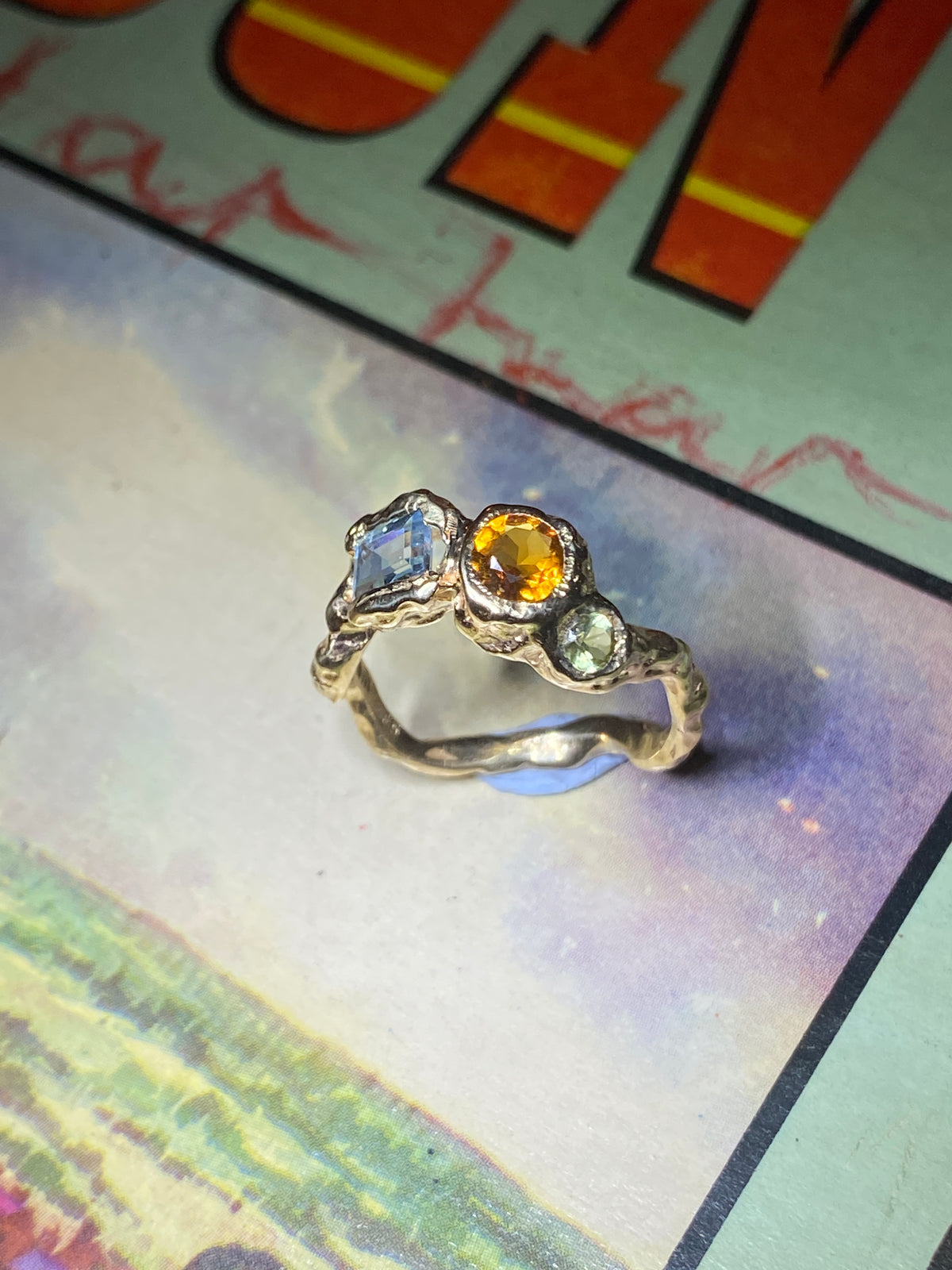 <p>14ct gold ring set with a green and blue tourmaline and a citrine as the center stone.</p>