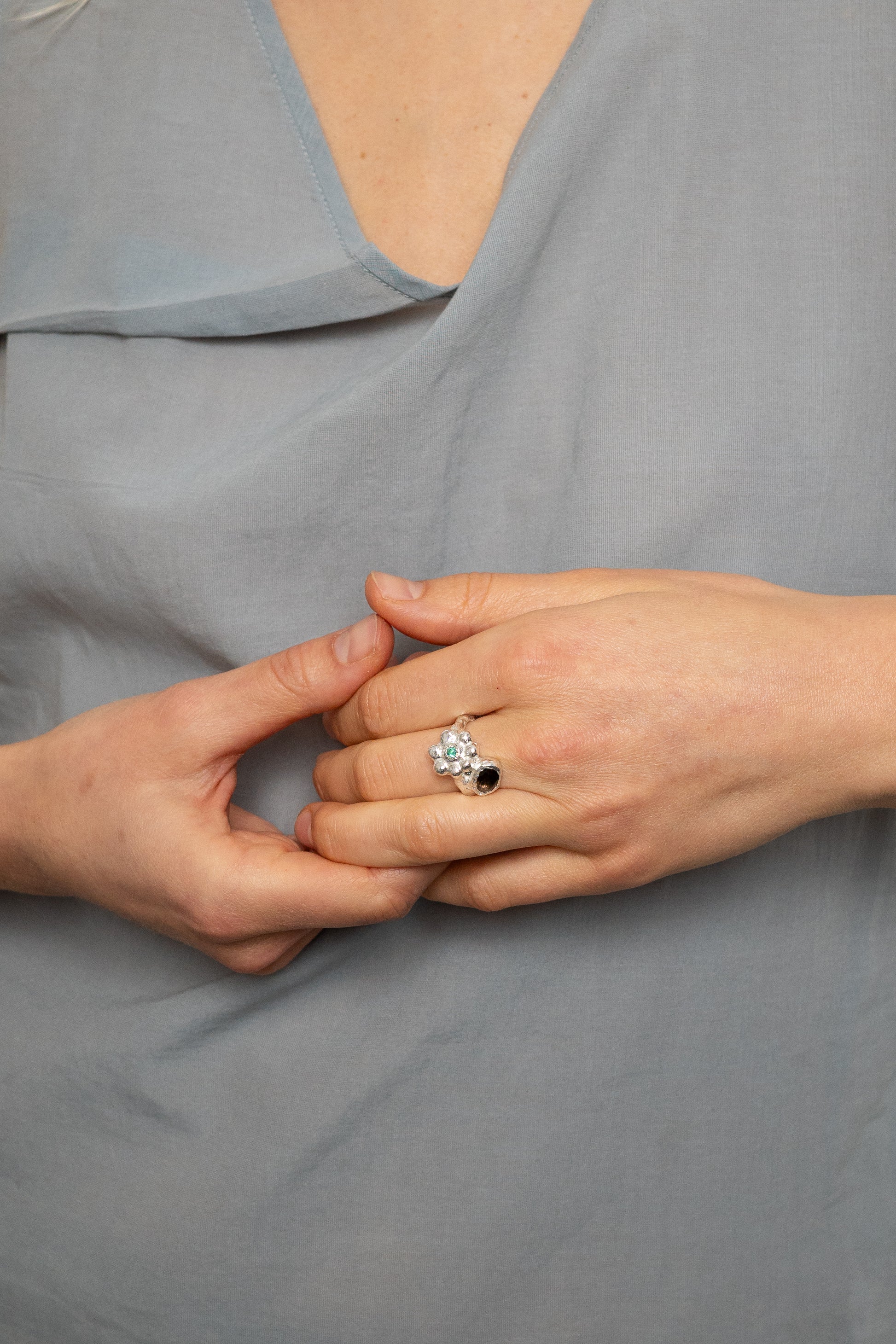 birgits finger with a green emerald and a smoky quartz
