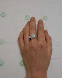 birgits finger with a green emerald and a smoky quartz