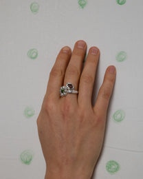 birgits finger with a green tourmaline and a piece of amber