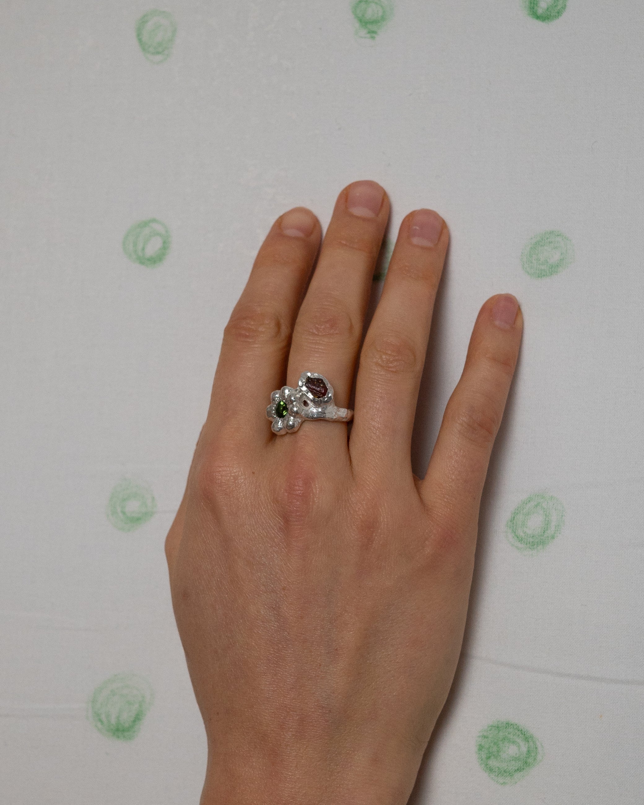 birgits finger with a green tourmaline and a piece of amber