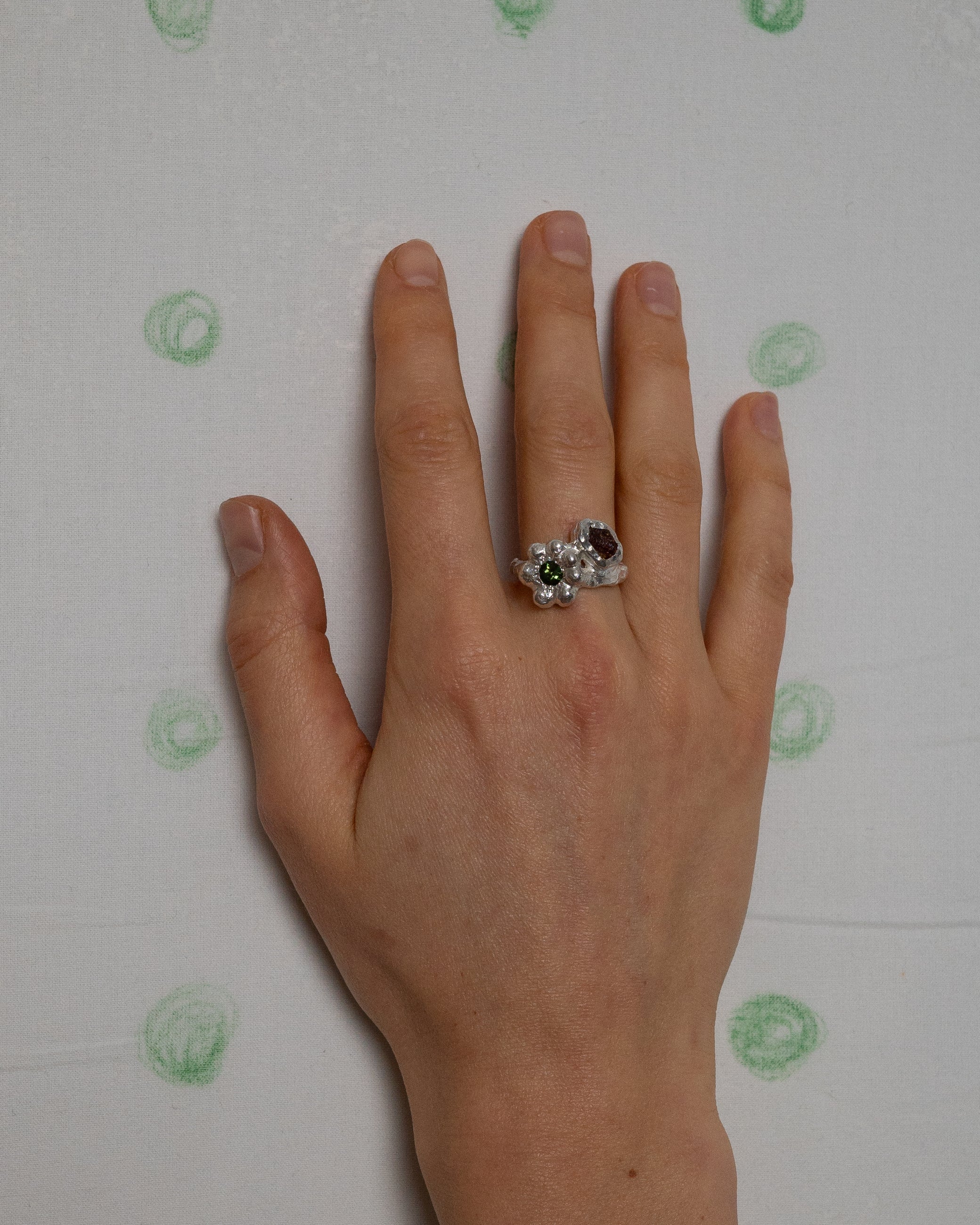 birgits finger with a green tourmaline and a piece of amber