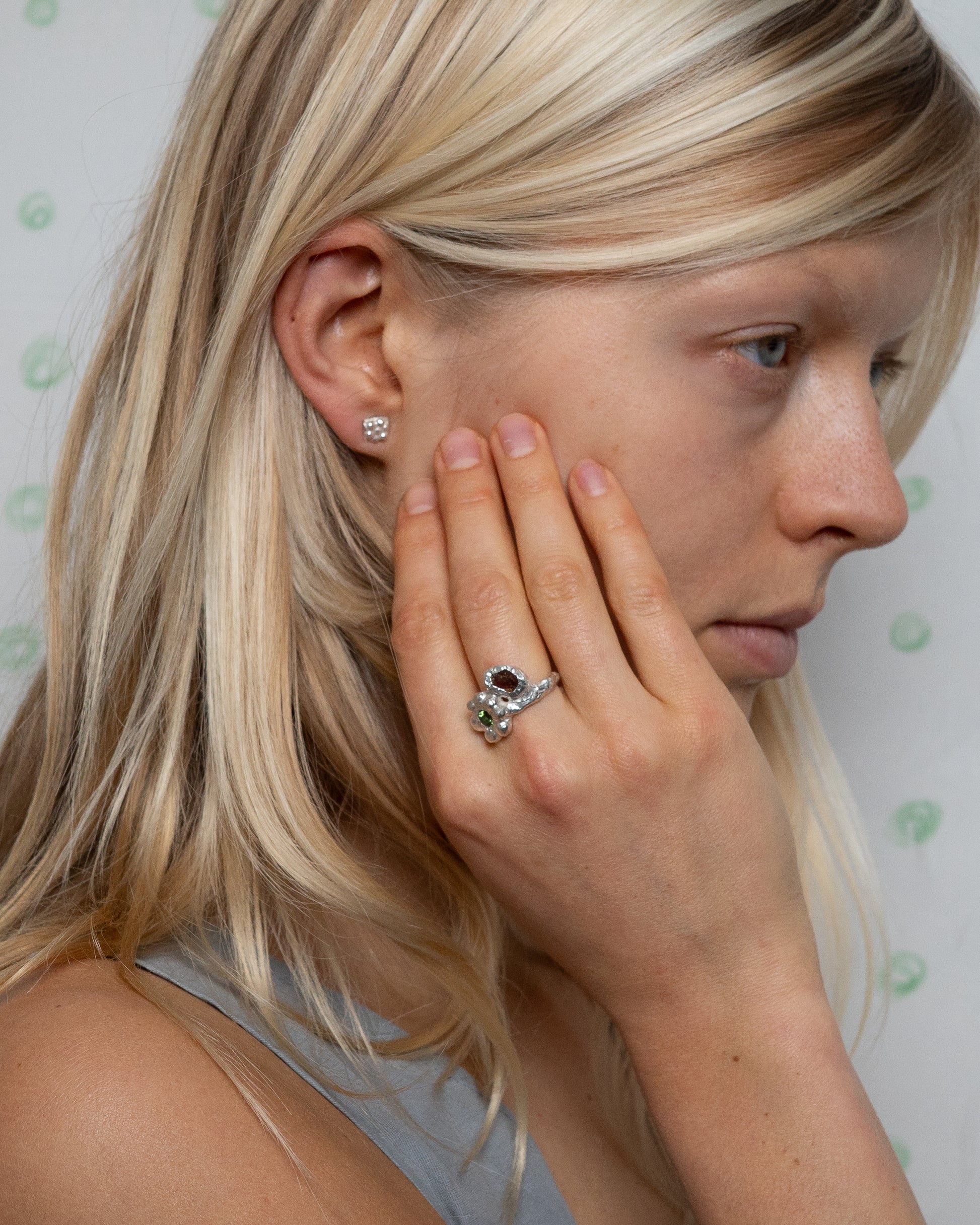 birgits finger with a green tourmaline and a piece of amber
