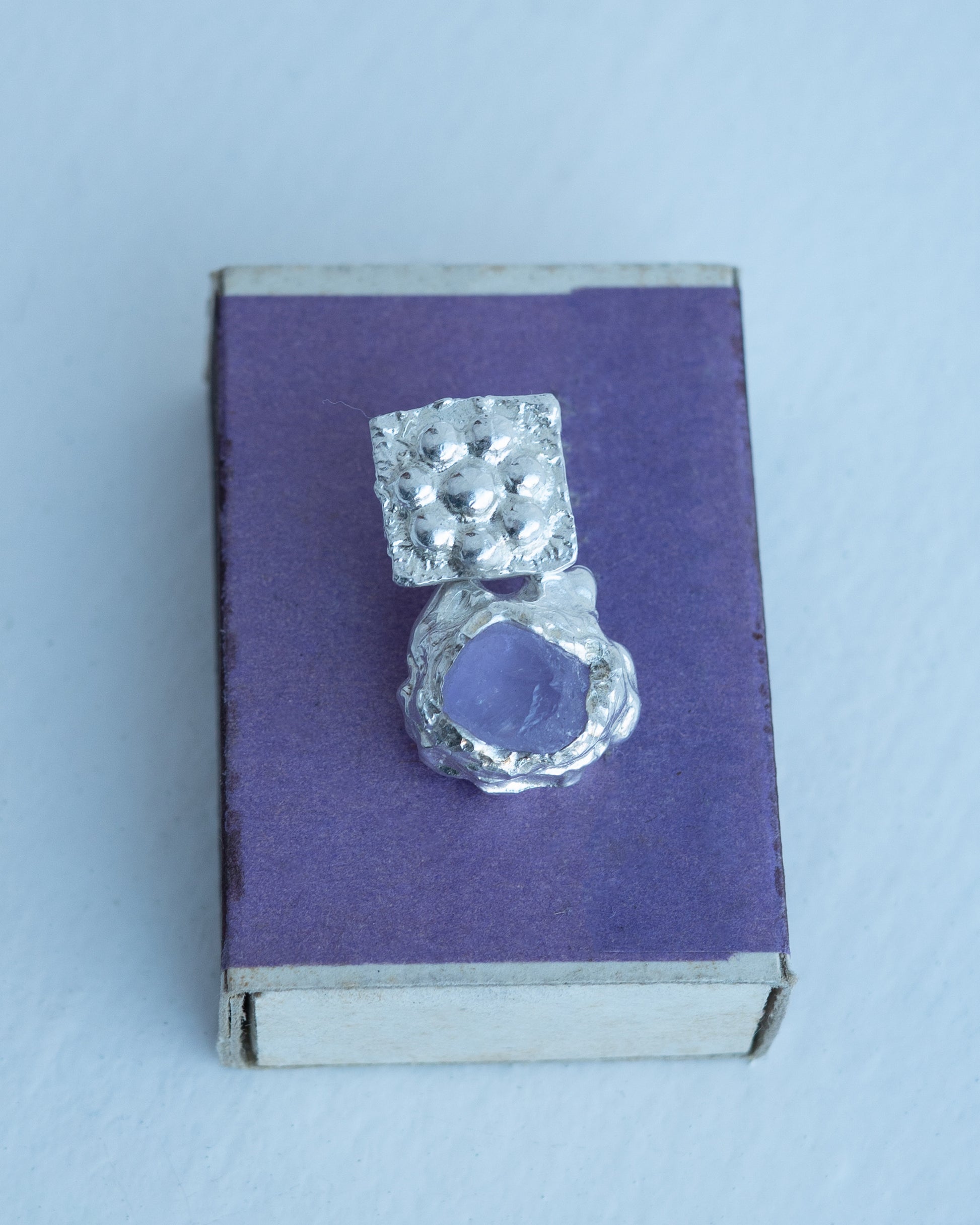 earringed with an amethyst