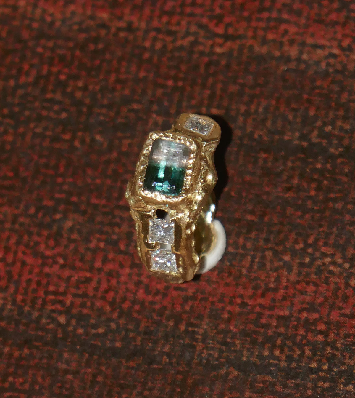 <p>18k gold ring set with a two coloured tourmaline and clients own diamonds. </p>